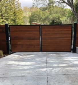 A custom driveway gate made from wood and metal frame.