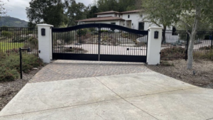 A black metal driveway gate.