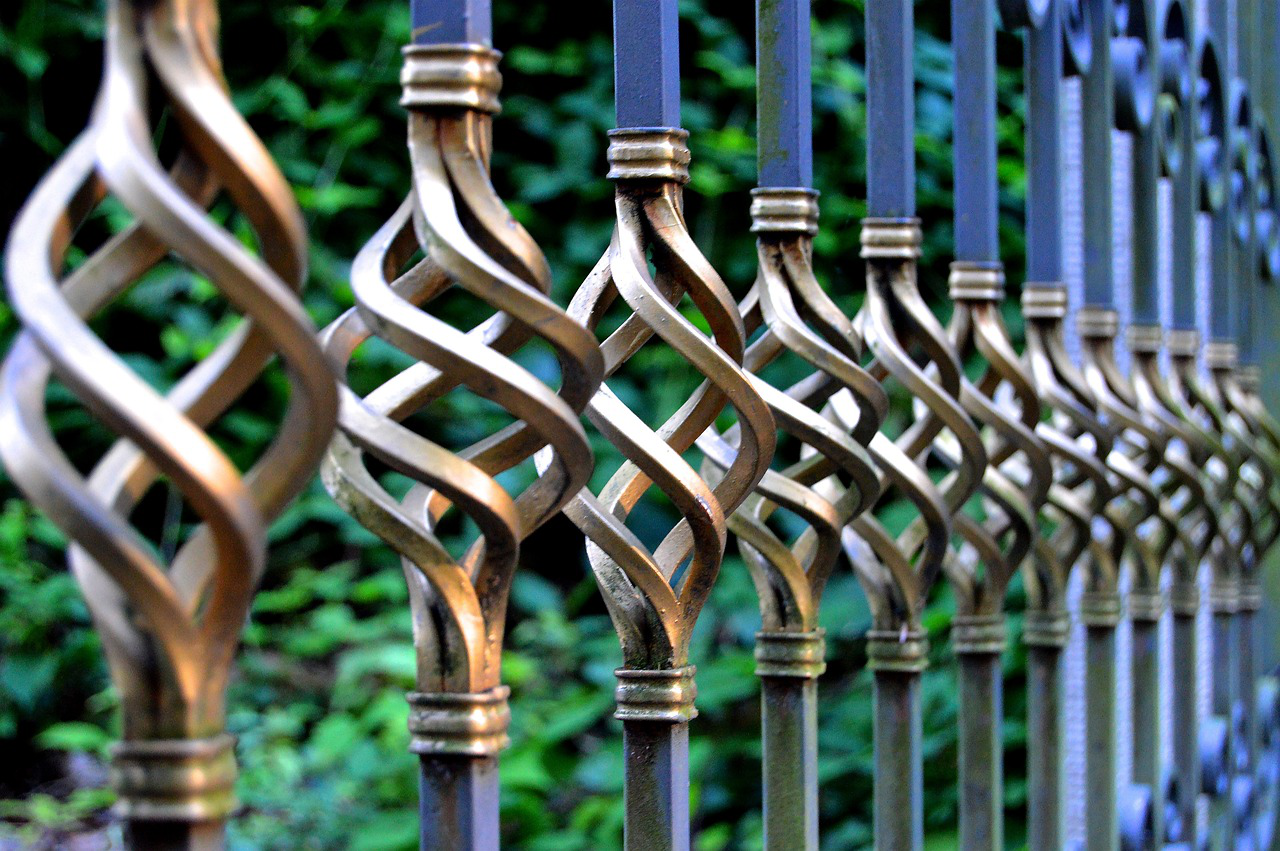 Wrought iron metal gate with decorative details.