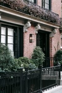 A residential building with an iron fence outside 