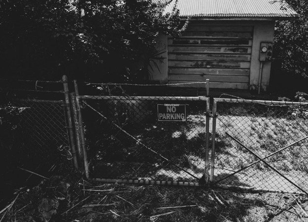 Custom chain link driveway gate installed in a residential area.