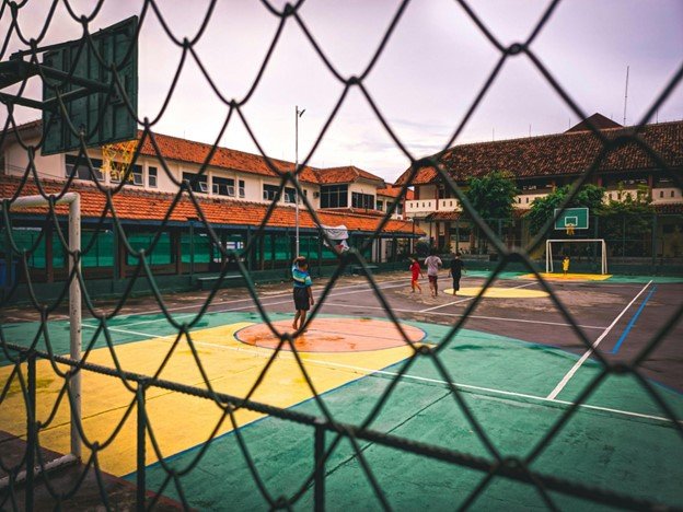 Court surrounded by chain link fencing.