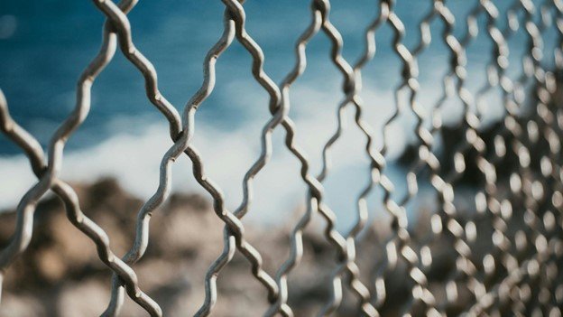 Close-up view of a large property enclosed with chain link fencing.