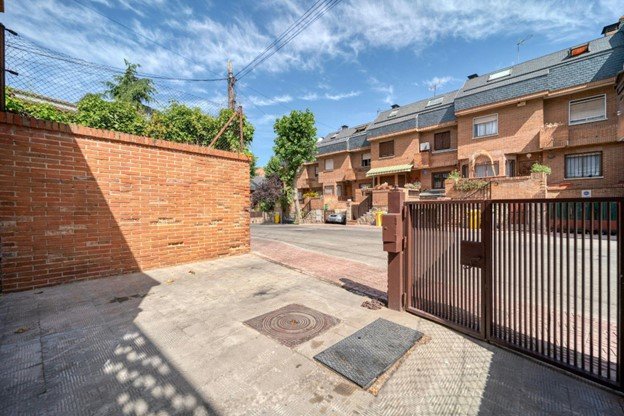 A commercial property with a metal fence and automated gates providing secure access.