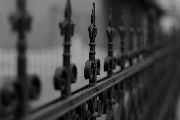 Wrought iron fence installation in a residential neighborhood.