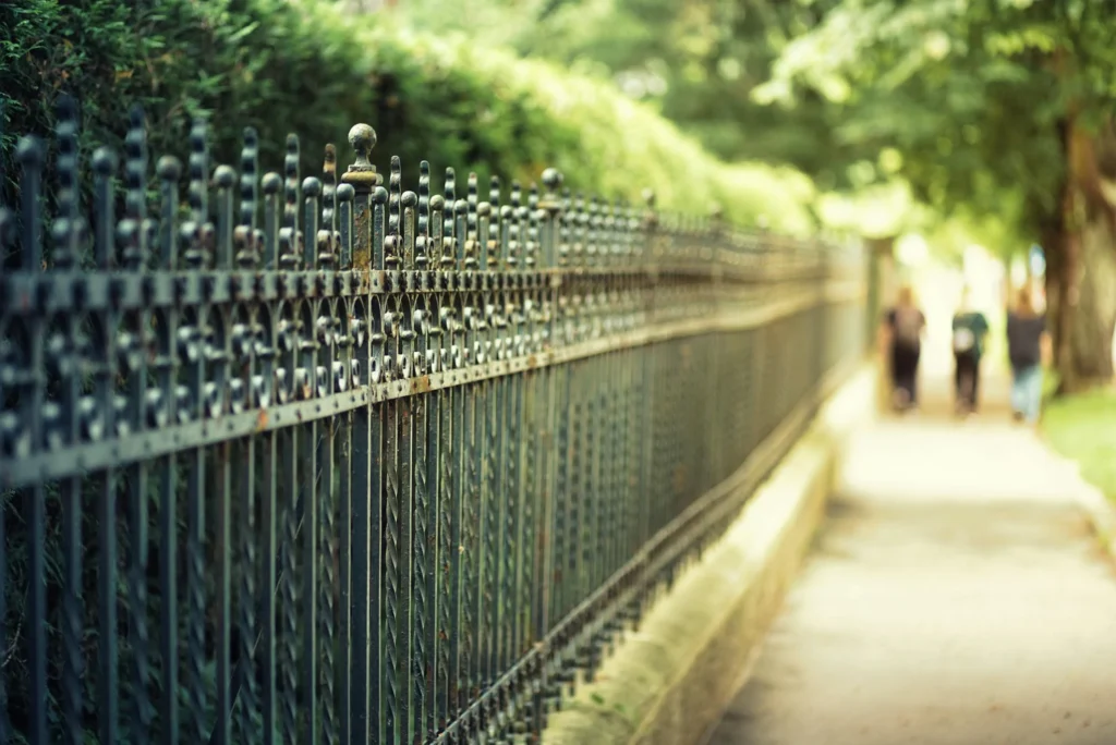 Close-up of decorative ironwork on a fence, exemplifying fence solutions with classic elegance.